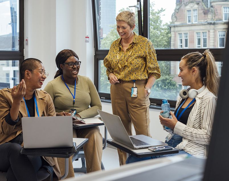 Photo of group of people having a discussion sitting around an office table
